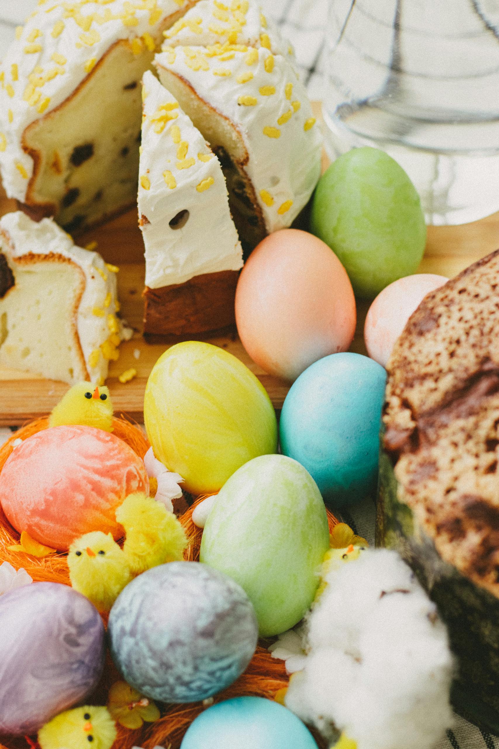 Colorful Easter composition with decorated eggs and festive cake, perfect for holiday celebrations.
